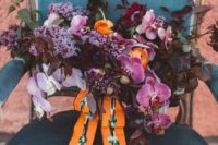 16 a colorful yet moody wedding bouquet with lilac, pink orchids, dark foliage and orange touches for a wow look