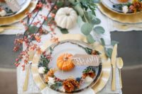 16 a rustic glam fall bridal shower table setting with a lucite table, bright florals, pumpkins and greenery
