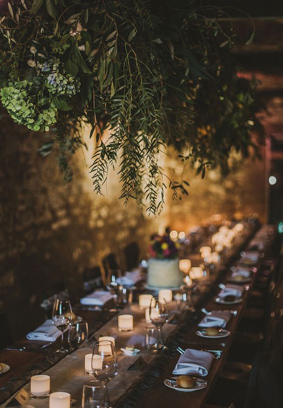 lush greenery decoration over the reception creates an outdoorsy feeling inside