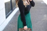 17 a cutout black top, an emerald pleated midi skirt, black shoes and a leopard clutch
