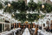 17 lush greenery overhead decorations with lanterns refresh the indoor venue and make it feel natural