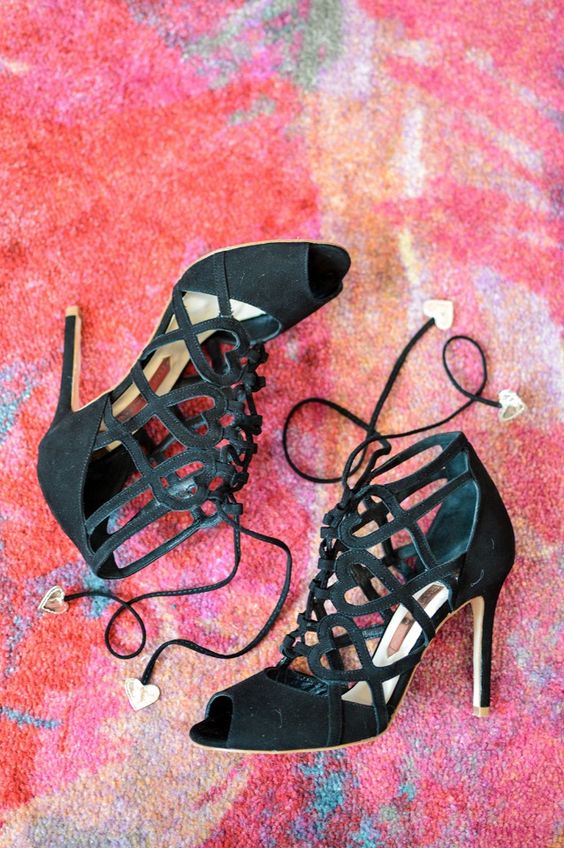 sassy black strappy heels with hearts bring a classy and girlish touch to your bridal look