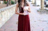 18 a burgundy velvet maxi dress with spaghetti straps, lilac shoes and a lilac clutch