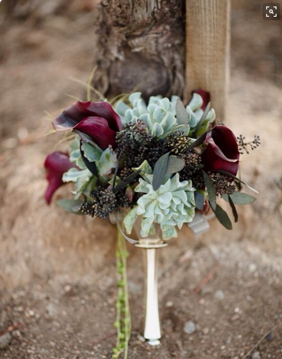 a moody Halloween wedding bouquet with succulents, dark callas and seeded eucalyptus