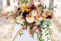 19 a colorful fall bouquet with yellow, pink, white, red flowers and greenery and red leaves plus a cascade
