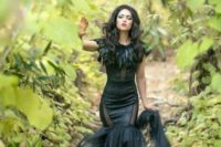 19 witch-inspired black mermaid wedding dress with feathers and sheer inserts plus a lush train
