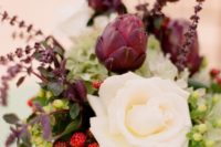 22 a creative wedding centerpiece with veggies, berries and a large white rose for a contrast