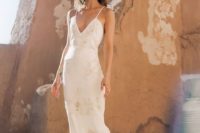 23 a slip wedding dress with gold lace appliques and a deep V-neckline plus a small train