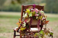 24 a wreath of burgundy dahlias and fall leaves is great for marking the couple’s chairs