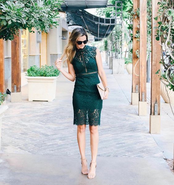 an emerald lace knee dress with a partly sheer skirt and bodice, a clutch andnude shoes