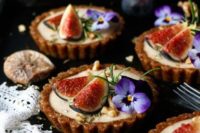 25 grain-free vegan tarts with a blend of spices and edible flowers on top
