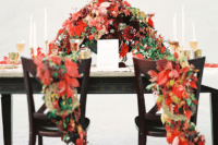 25 lush red and green fall leaf posies for the couple’s chairs and a matching luxurious floral centerpiece