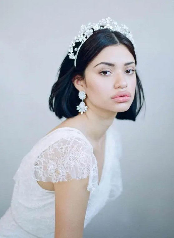 a black long bob with central parting and a rhinestone floral tiara and matching statement earrings is amazing