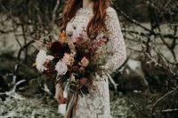 a moody fall bride with long red hair down and a creative metallic crown for a more eye-catchy look