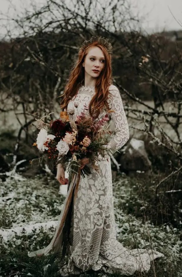 a moody fall bride with long red hair down and a creative metallic crown for a more eye-catchy look