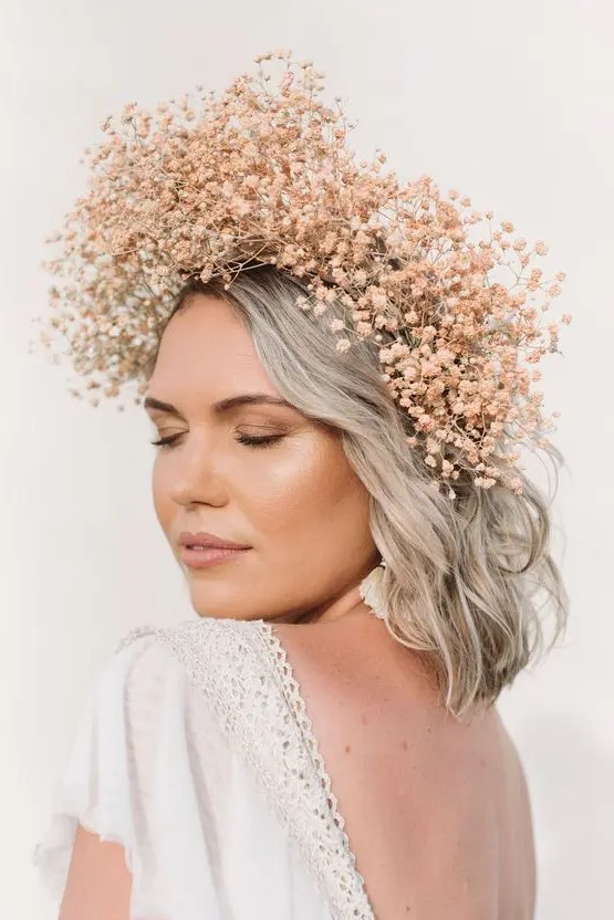a peachy pink dried baby's breath flower crown is a stylish and very delicate addition to a spring bridal look