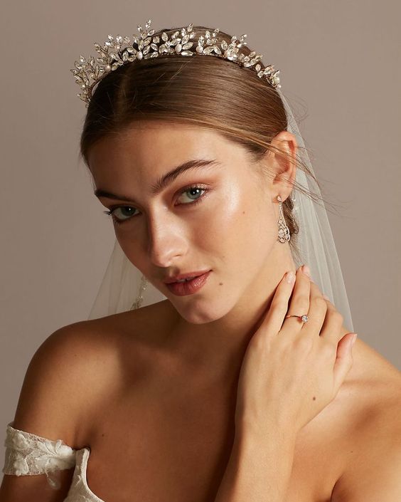 a refined and chic rhinestone bridal tiara paired with a veil for a formal and chic refined bridal look