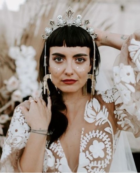 an embellished silver crown with rhinestones and hanging chains on each side will perfectly fit a boho bridal look