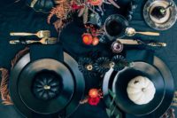 02 a black tablecloth, black pumpkins and bright flowers plus matte black plates