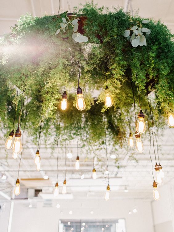 a large greenery wedding chandelier with lots of bulbs hanging down is a great idea for a reception or a dance floor