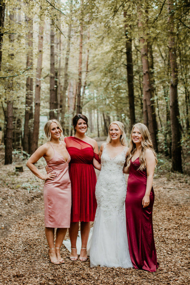 The bridesmaids were wearing mismatching dresses in red, pink and burgundy