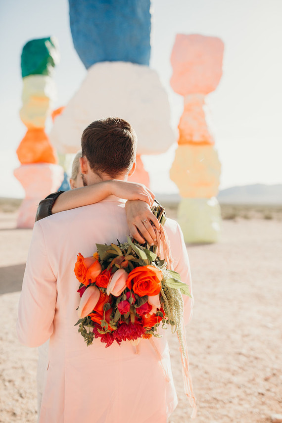 The wedding bouquet was a bold one, in orange, red and blush to match the shoot scheme