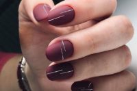 03 matte burgundy nails with thin white stripes is an ultra-modern take on usual wine shades