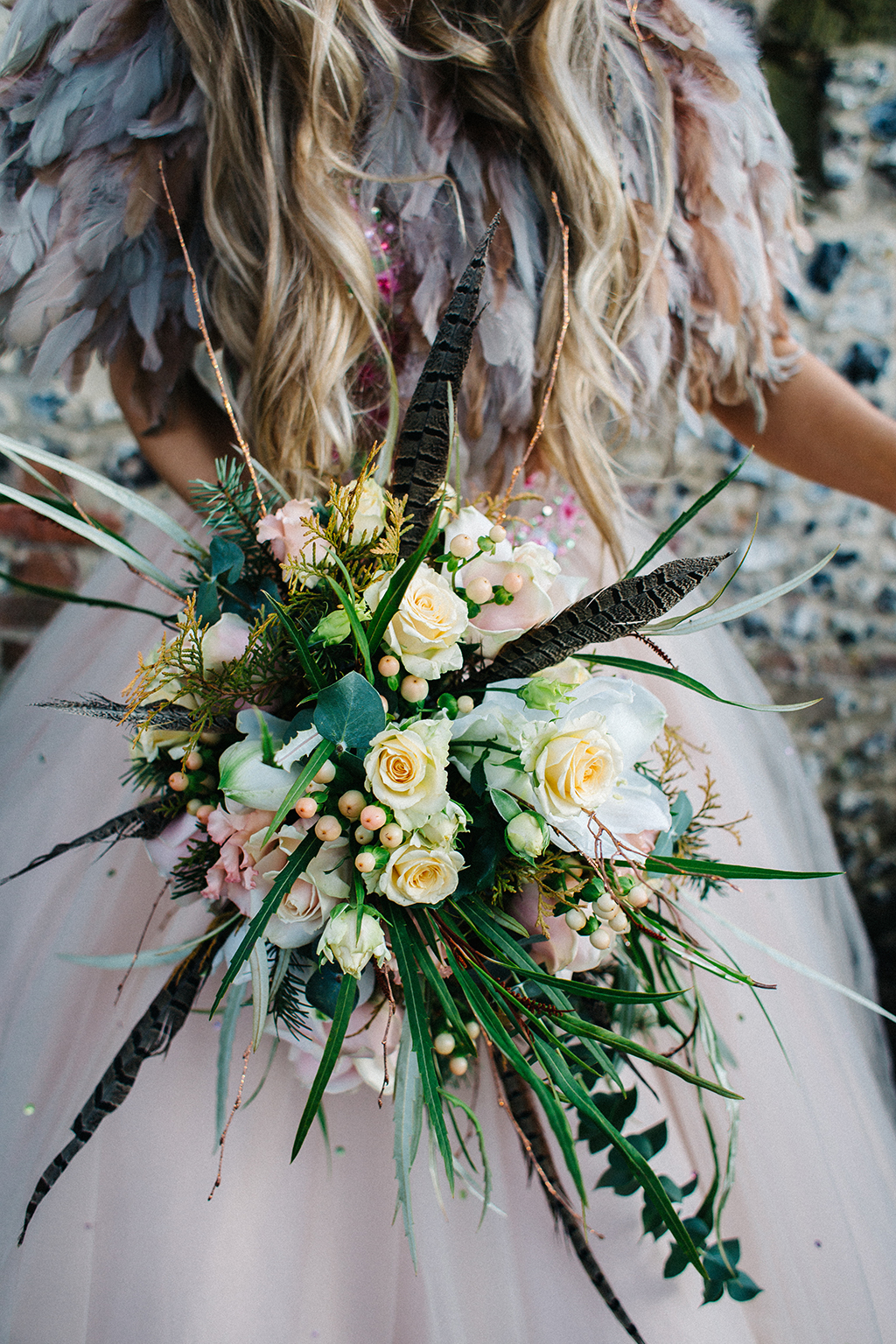 The bouquet was a creative and textural piece with much foliage and feathers