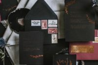 04 a black wedding stationery suite with copper foil, vintage stamps and a burgundy envelope
