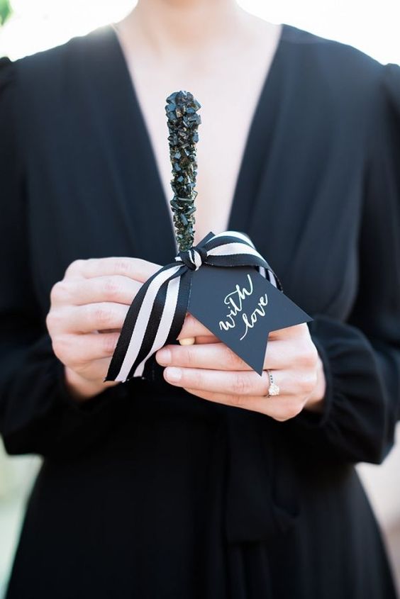 black rock candy favors with ribbon and tags are a stylish and cool idea for Halloween