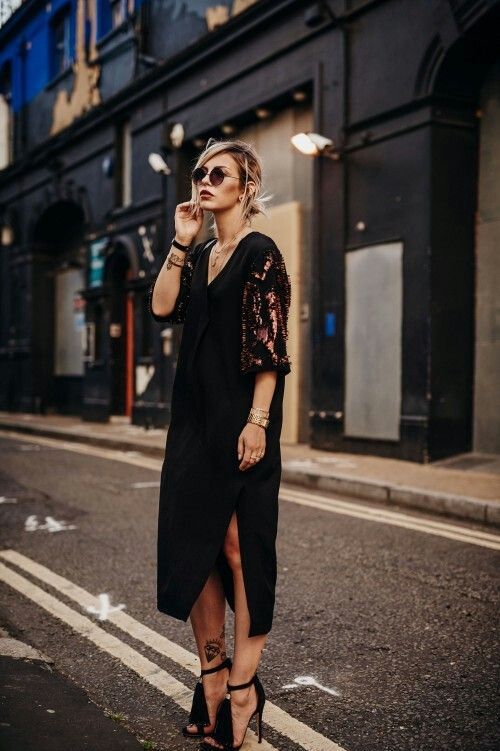 a comfy black midi dress with a side slit, copper sequin sleeves and tassel heels