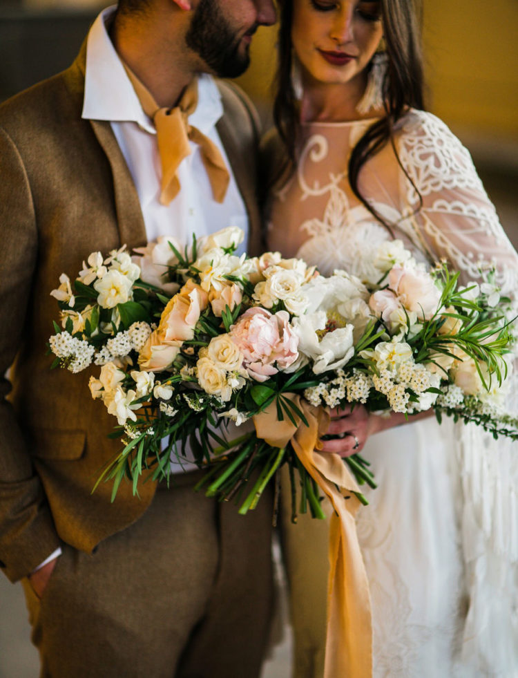 The wedding bouquet was lush and neutral, with blush and white blooms