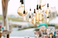 06 a boho tablescape with large bulbs hanging over it for more light and an industrial feel