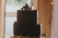 06 a chic black and gold Halloween wedding cake topped with berries and foliage is a bold modern solution