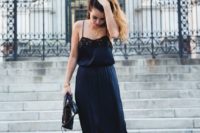 06 a navy slip dress with black lace inserts and black heeled sandals for a statement