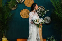 07 The wedding backdrop was a teal wall with woven baskets and greenery