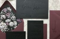 07 a black and plum-colored wedding invitation suite with dark floral lining and pressed calligraphy for a moody wedding