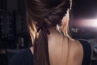 07 a low twisted ponytail with a bump, locks down and a ribbon is a chic modern option