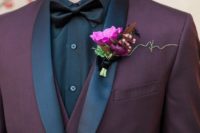 07 a stylish three-piece suit in burgundy with black lapels and a black bow tie for a moody look
