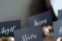 07 chic black escort cards with calligraphy and gold foil