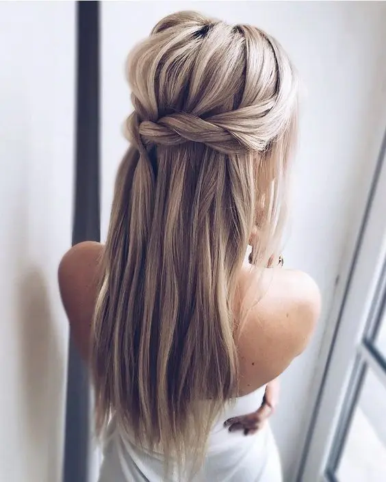 a Dutch braided half updo hairstyle with long hair down and a bump for those who don't want any waves