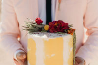 10 The wedding cake was a buttercream one in yellow and white topped with bold blooms