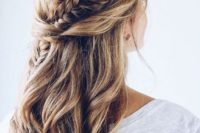 10 a chic half updo with waves, twists and a fishtail braid going down for a boho bridesmaid