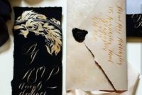 10 a luxurious wedding stationery set in off-white and black with gold calligraphy for a refined Halloween wedding