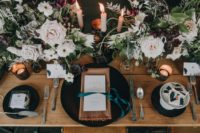11 The wedding tablescape was done with matte black chargers, beige napkins and candles