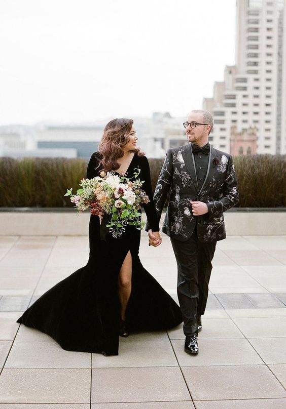 a black wedding suit printed with owls, black shoes and a black shirt plus a bow tie