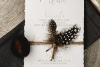 11 a wedding menu with twine, feathers and a nut attached for a fall boho wedding
