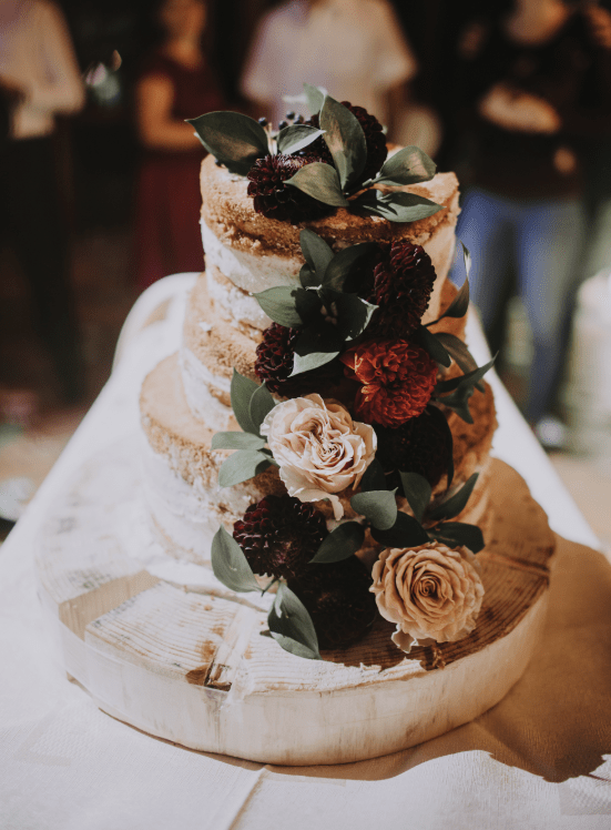 The wedding cake was a naked one topped with elegant blooms