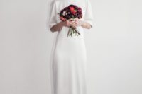 12 a plain silk midi wedding dress with long sleeves, a high neckline and red shoes for a minimalist bride