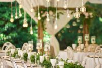 12 an overhead wedding decoration with cascading ferns and some bulbs hangign down